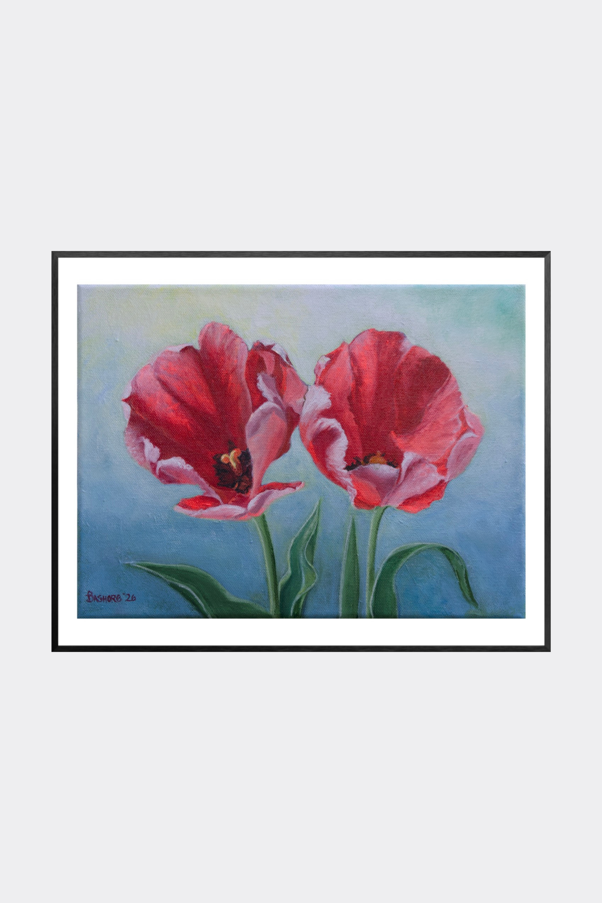 Framed artwork of two red tulips on a light blue background